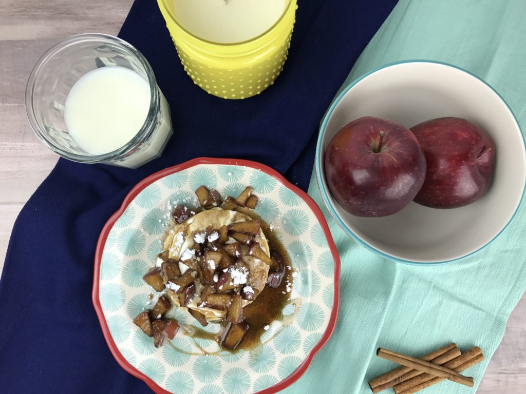 Old fashioned and fluffy pancakes topped with sour cream, fresh apples cooked in a cinnamon syrup glaze and powdered sugar make these Apple Cinnamon Pancakes the best fall recipe for breakfast, brunch, or dinner.