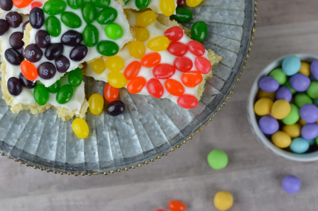 Rainbow Sugar Cookie Bark is super playful and fun for Easter. Each piece has multiple colors of STARBURST® Jellybeans - "Hop to It" & taste the rainbow!