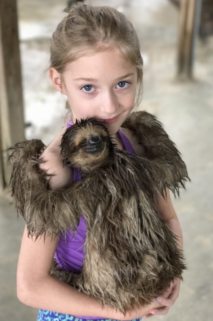 Are you traveling to Roatan, Honduras? I am telling you about our time in Roatan including hugging a sloth and horseback riding in the ocean.