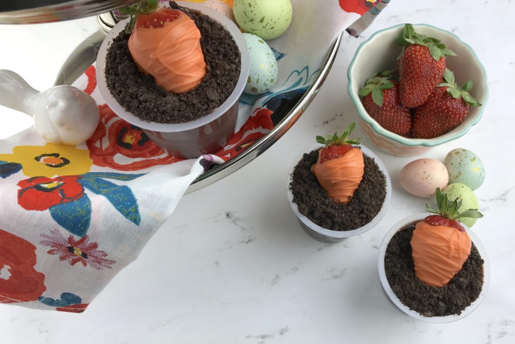 These adorable Carrot Patch Dirt Cups are perfect for spring and easy to make using store bought pudding cups, topped with crumbled chocolate sandwich cookies, and chocolate-covered strawberry “carrots”.  