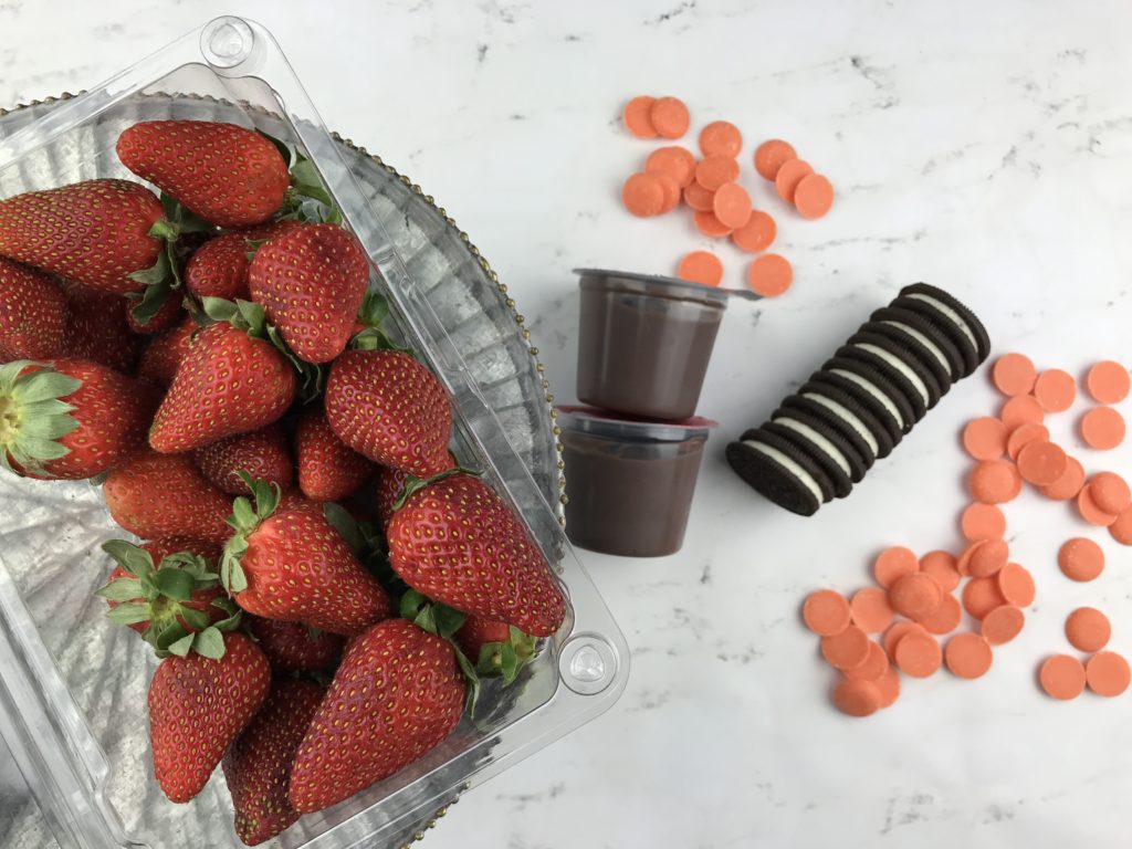These adorable Carrot Patch Dirt Cups are perfect for spring and easy to make using store bought pudding cups, topped with crumbled chocolate sandwich cookies, and chocolate-covered strawberry “carrots”.  