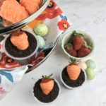 These adorable Carrot Patch Dirt Cups are perfect for spring and easy to make using store bought pudding cups, topped with crumbled chocolate sandwich cookies, and chocolate-covered strawberry “carrots”.  