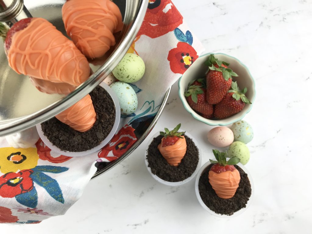 These adorable Carrot Patch Dirt Cups are perfect for spring and easy to make using store bought pudding cups, topped with crumbled chocolate sandwich cookies, and chocolate-covered strawberry “carrots”.  