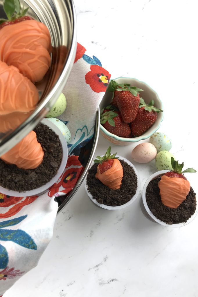 These adorable Carrot Patch Dirt Cups are perfect for spring and easy to make using store bought pudding cups, topped with crumbled chocolate sandwich cookies, and chocolate-covered strawberry “carrots”.  