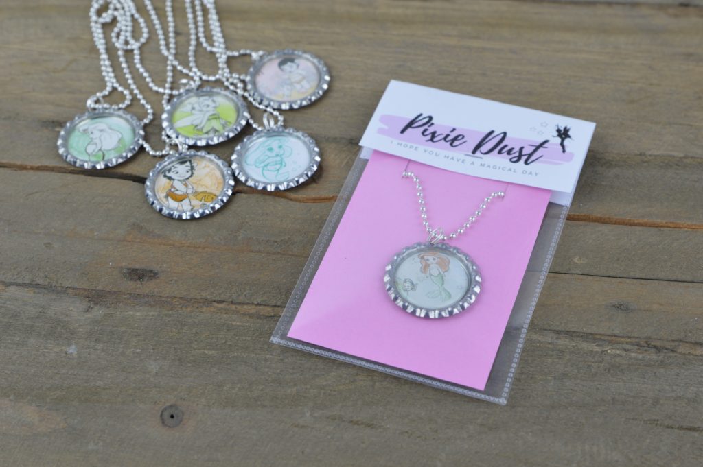 These fun and easy bottle cap necklaces are a great DIY craft for fish extender or pixie dust gifts for your next Disney Cruise.