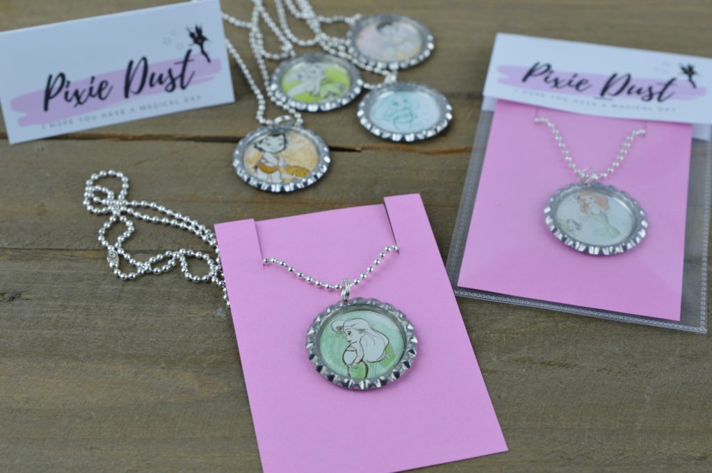 These fun and easy bottle cap necklaces are a great DIY craft for fish extender or pixie dust gifts for your next Disney Cruise.