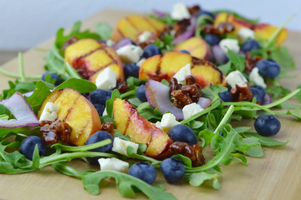 Grilled Peach Salad is the best summer side dish recipe!  The peaches and onions are grilled and served with arugula, blueberries, candied pecans, and blue cheese. 