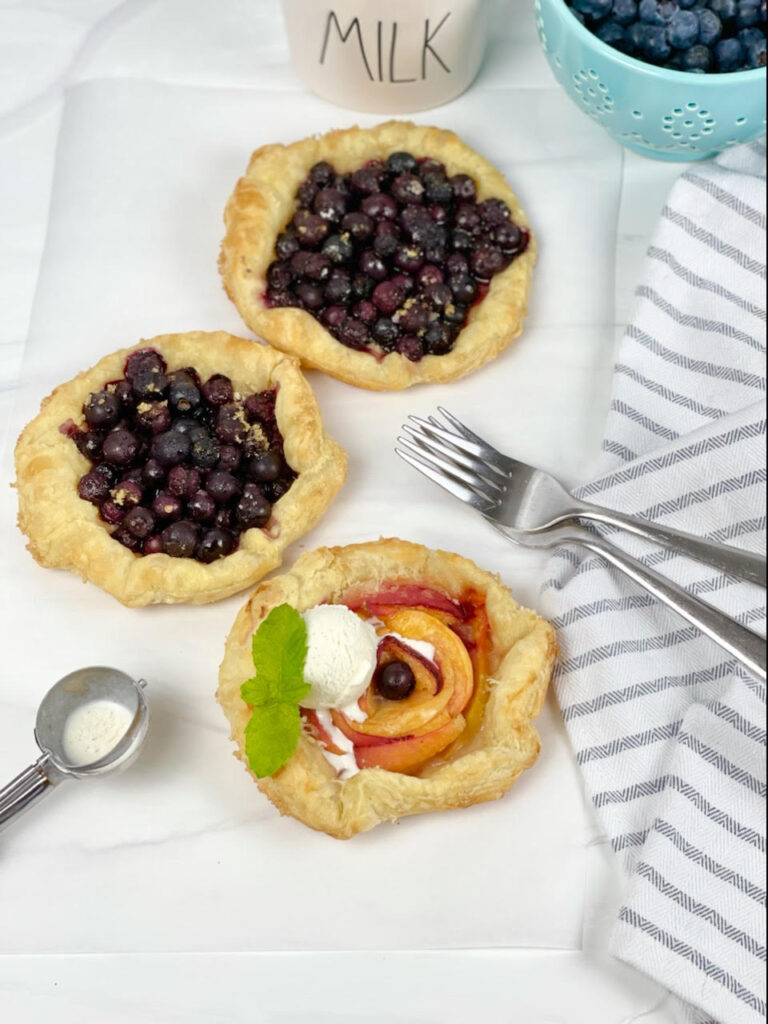 Gorgeous mini peach blueberry galettes are the perfect, fun, and simple dessert with seasonal fruit.
