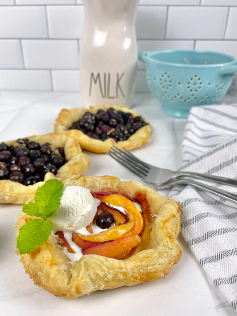 Gorgeous mini peach blueberry galettes are the perfect, fun, and simple dessert with seasonal fruit.