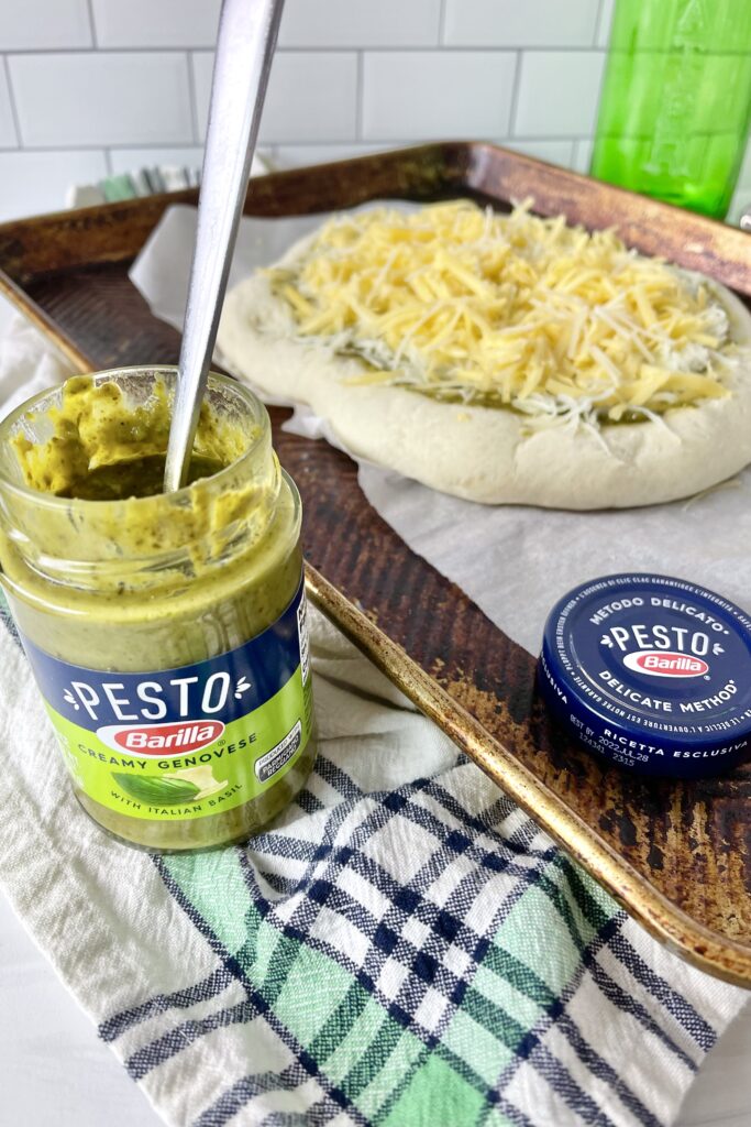 Are you always looking for quick dinner ideas that the whole family will enjoy? This flavorful and savory Three Cheese Pesto Pizza is a family favorite.