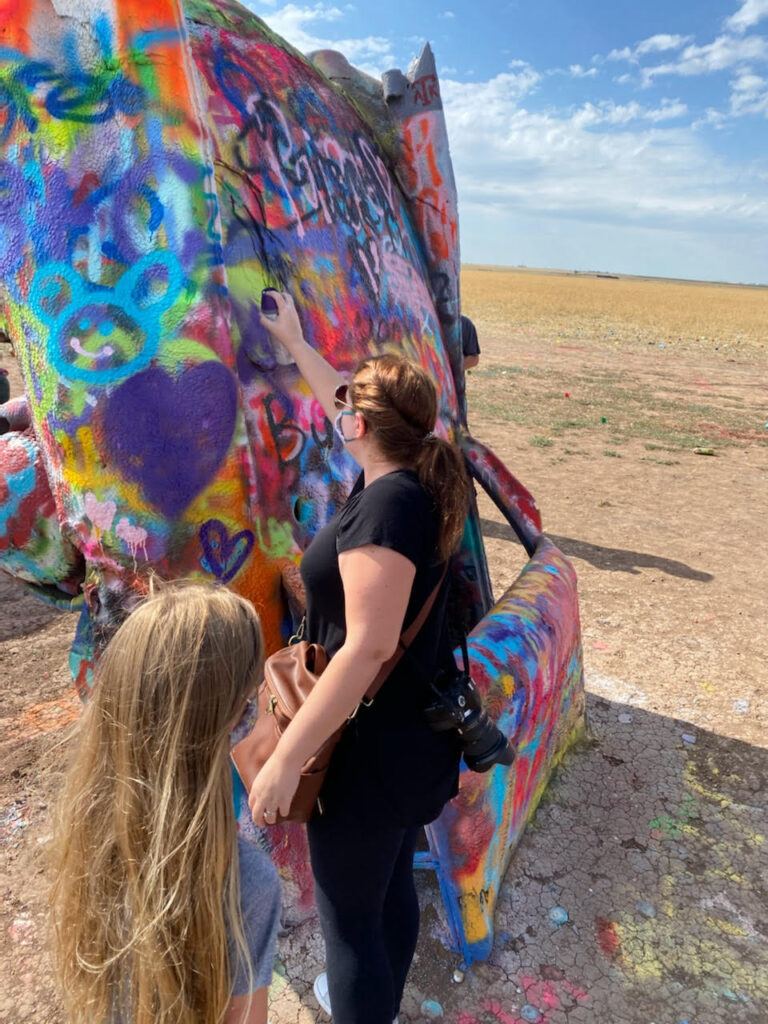 Everything you need to know about visiting Cadillac Ranch. This kitsch roadside attraction located near Amarillo, Texas is an experience you don't want to miss.