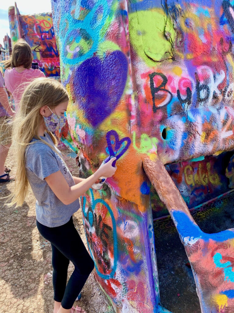 Everything you need to know about visiting Cadillac Ranch. This kitsch roadside attraction located near Amarillo, Texas is an experience you don't want to miss.