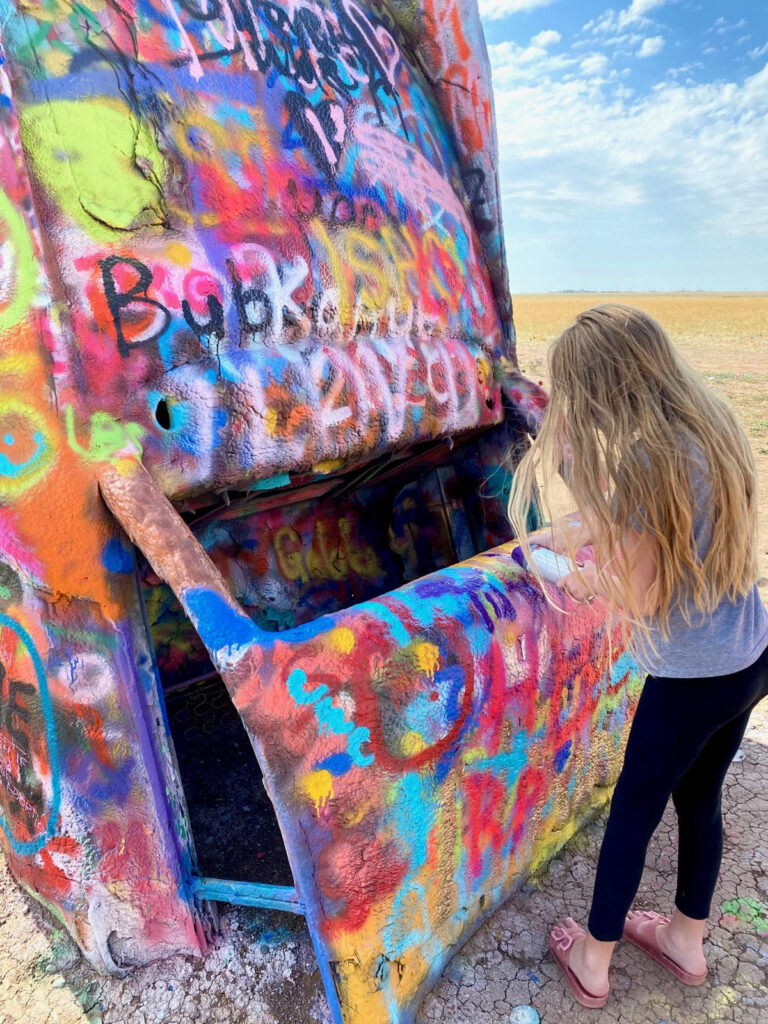 Everything you need to know about visiting Cadillac Ranch. This kitsch roadside attraction located near Amarillo, Texas is an experience you don't want to miss.
