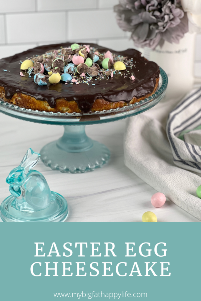 This creamy Easter egg cheesecake is packed with mini chocolate eggs, has a graham cracker crust, and is topped with chocolate ganache and mini chocolate eggs.