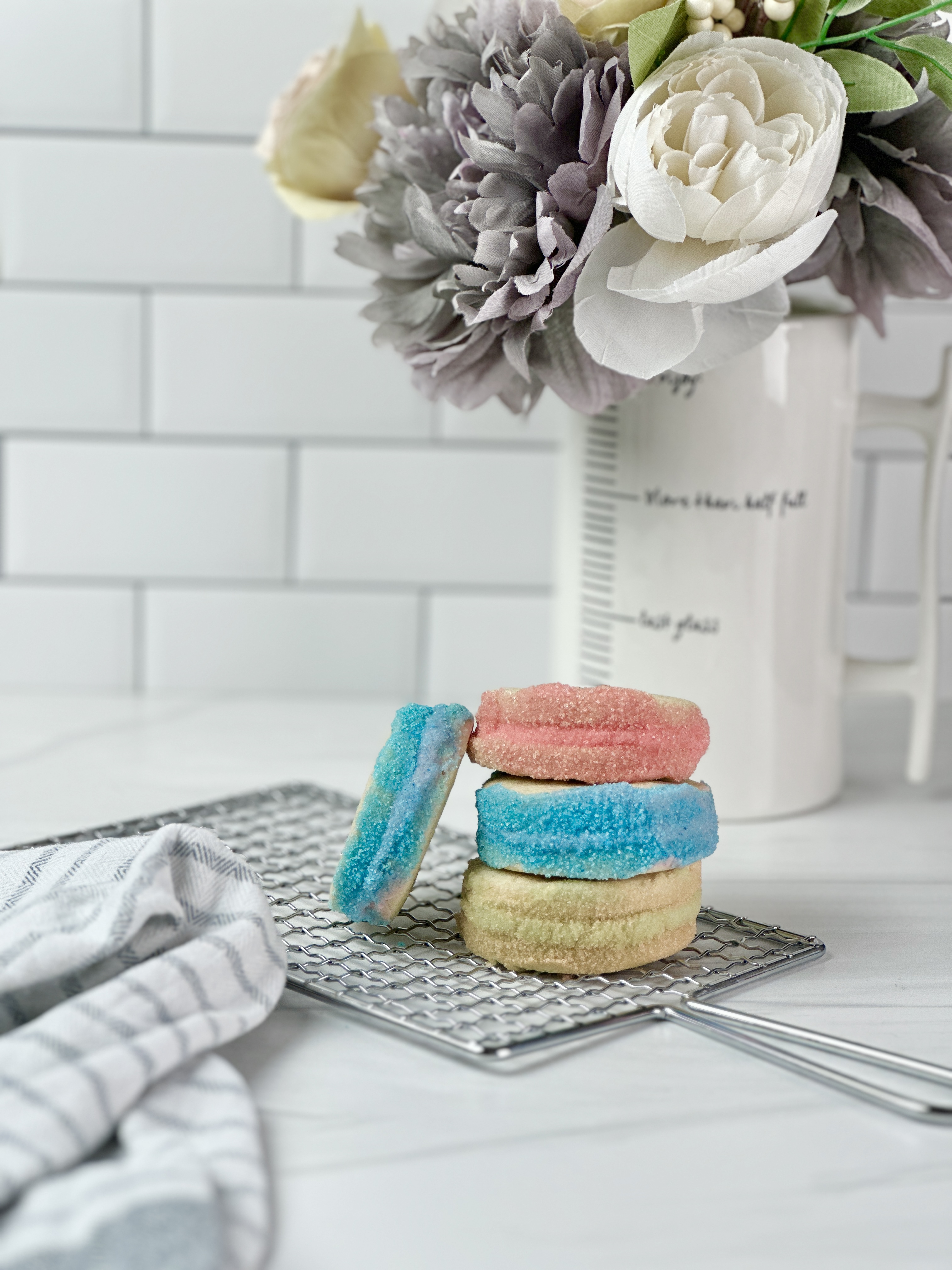 These soft, buttery sandwich cookies are filled with delicious spring flavors and rolled in colorful sugars for a super cute Easter-inspired dessert.