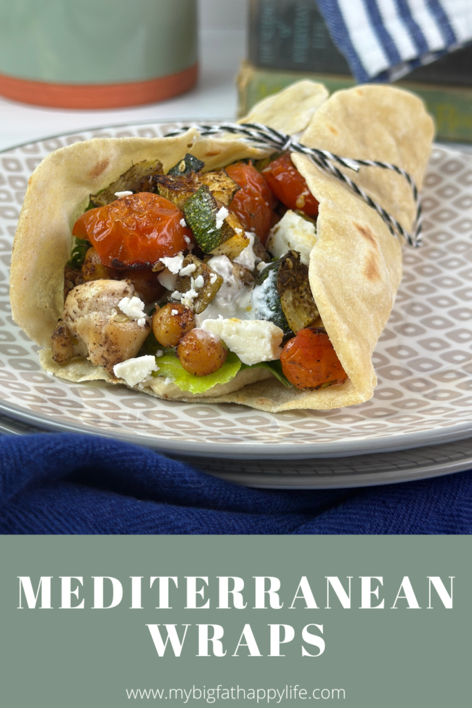 These Mediterranean Wraps feature a pita/tortilla stuffed with roasted vegetables, chickpeas, seasoned chicken, hummus, and a feta sauce.