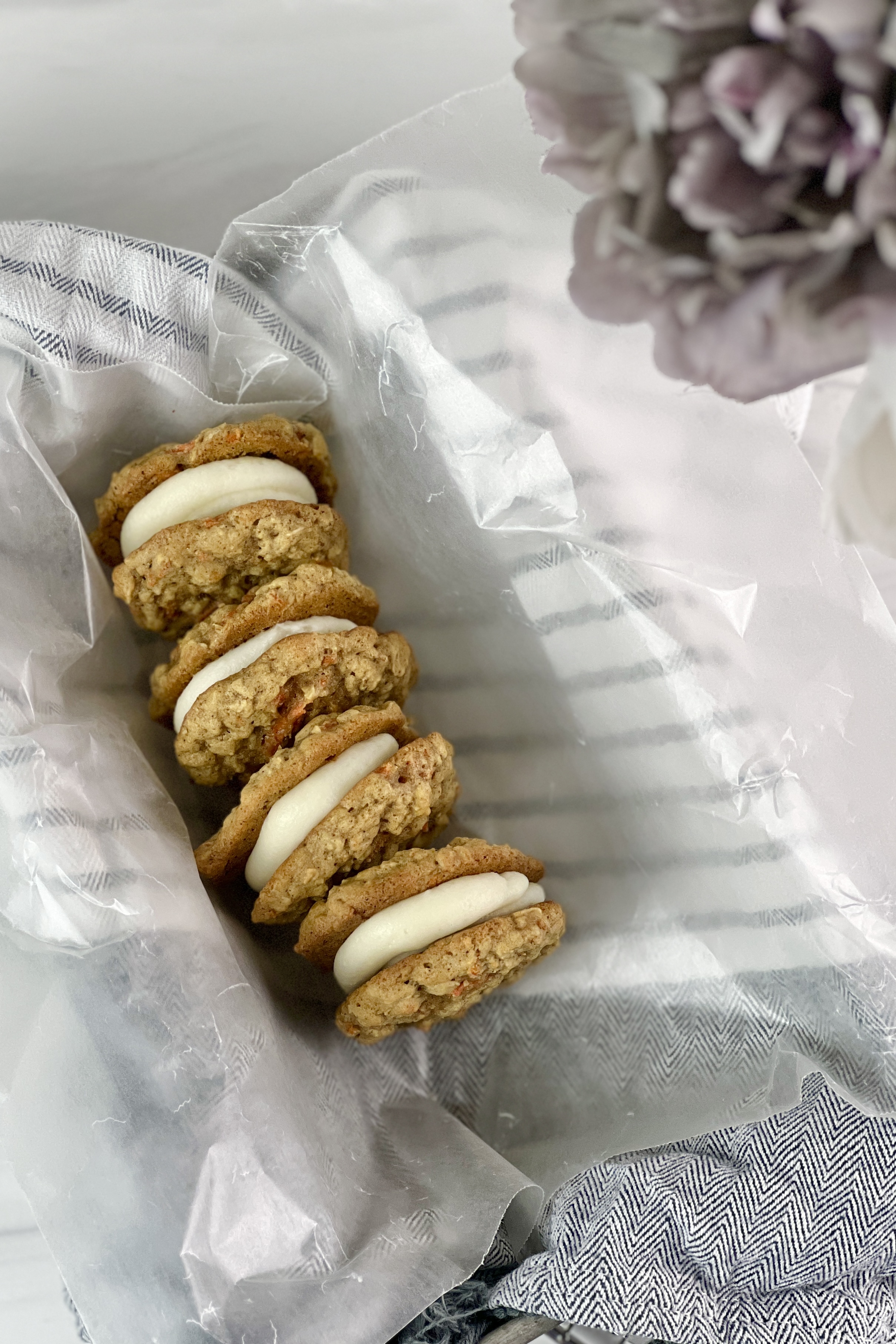 These soft and chewy carrot cake sandwich cookies filled with cream cheese frosting are delicious and easy to make. 